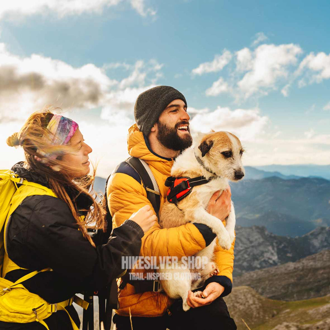 Hikers with dog enjoying mountain view on one of the 10 best dog-friendly hiking trails in the USA